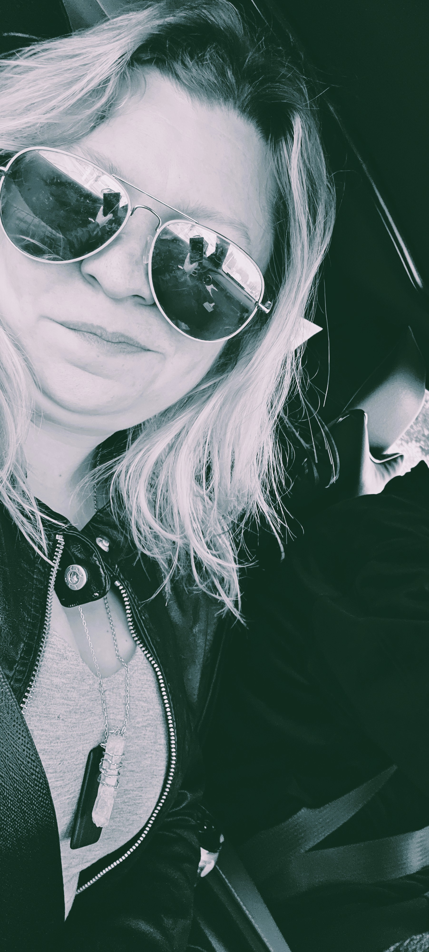 Mollie Davis wearing sunglasses in a candid black-and-white photo